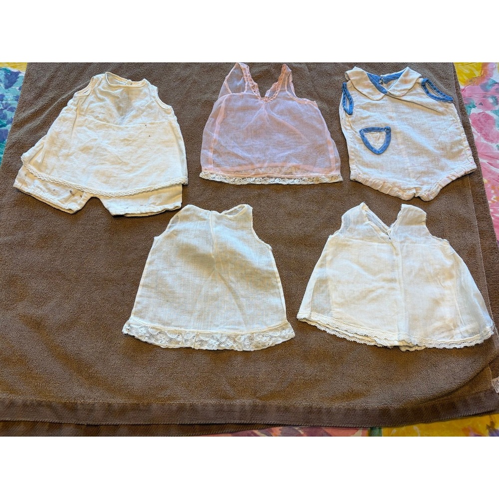 Four vintage doll slips and a jumper outfit